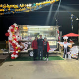 Bakery trailer in real operation with customers, cake display cabinet, menu board, and branded exterior