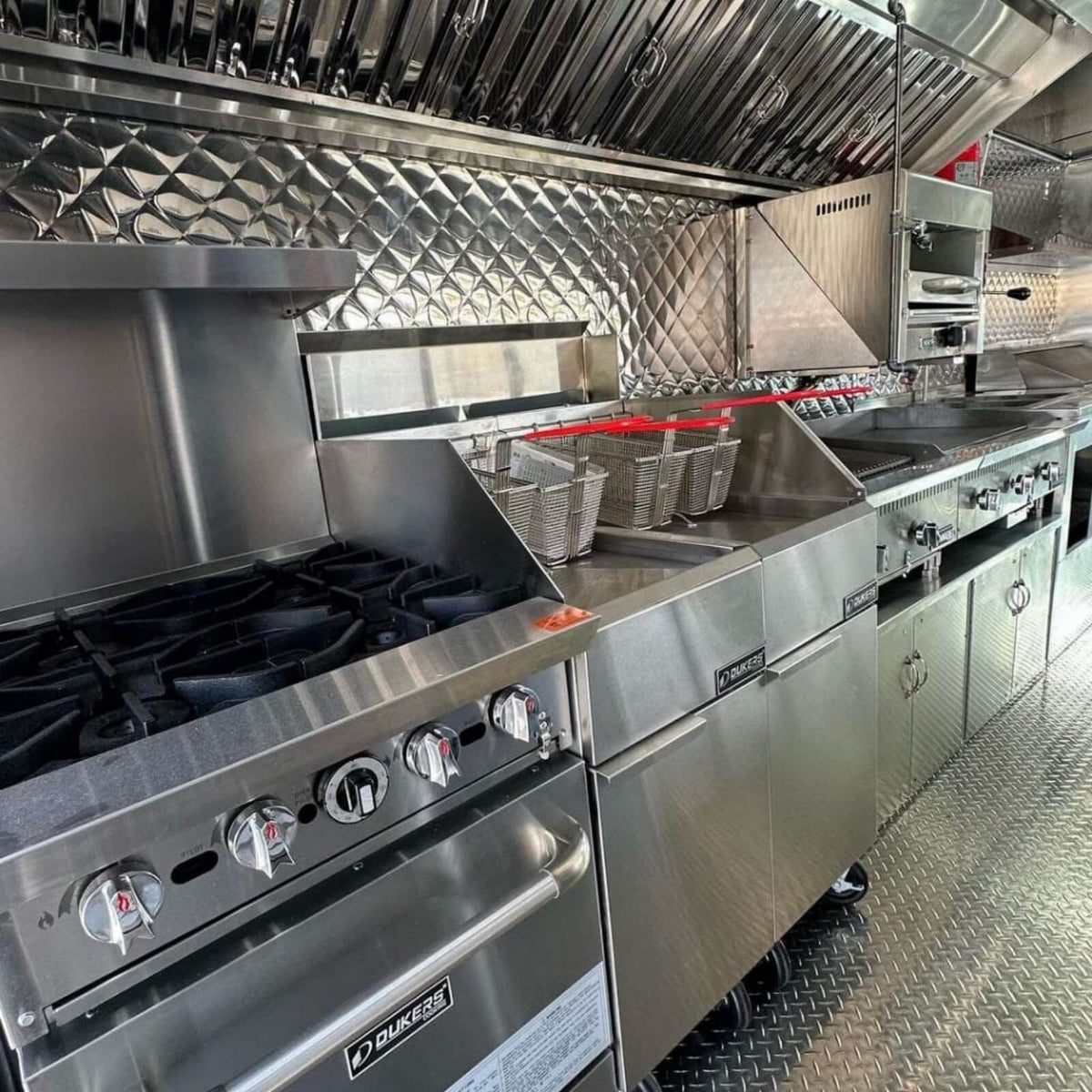 BBQ food truck interior with commercial burners, deep fryer, griddle and exhaust hood – full kitchen mobile catering truck for sale