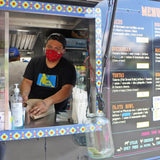 Food truck service window with chef and menu board showing tacos, quesadilla and fajita bowl – custom mobile catering truck