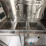 Interior view of a beverage trailer with stainless steel three compartment sink for commercial drink preparation and cleaning