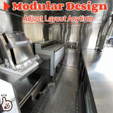 Commercial pizza trailer interior with stainless steel prep tables, refrigeration system, and professional pizza oven workspace.
