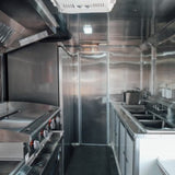BBQ food truck interior stainless steel kitchen with grill, exhaust hood and 3-compartment sink