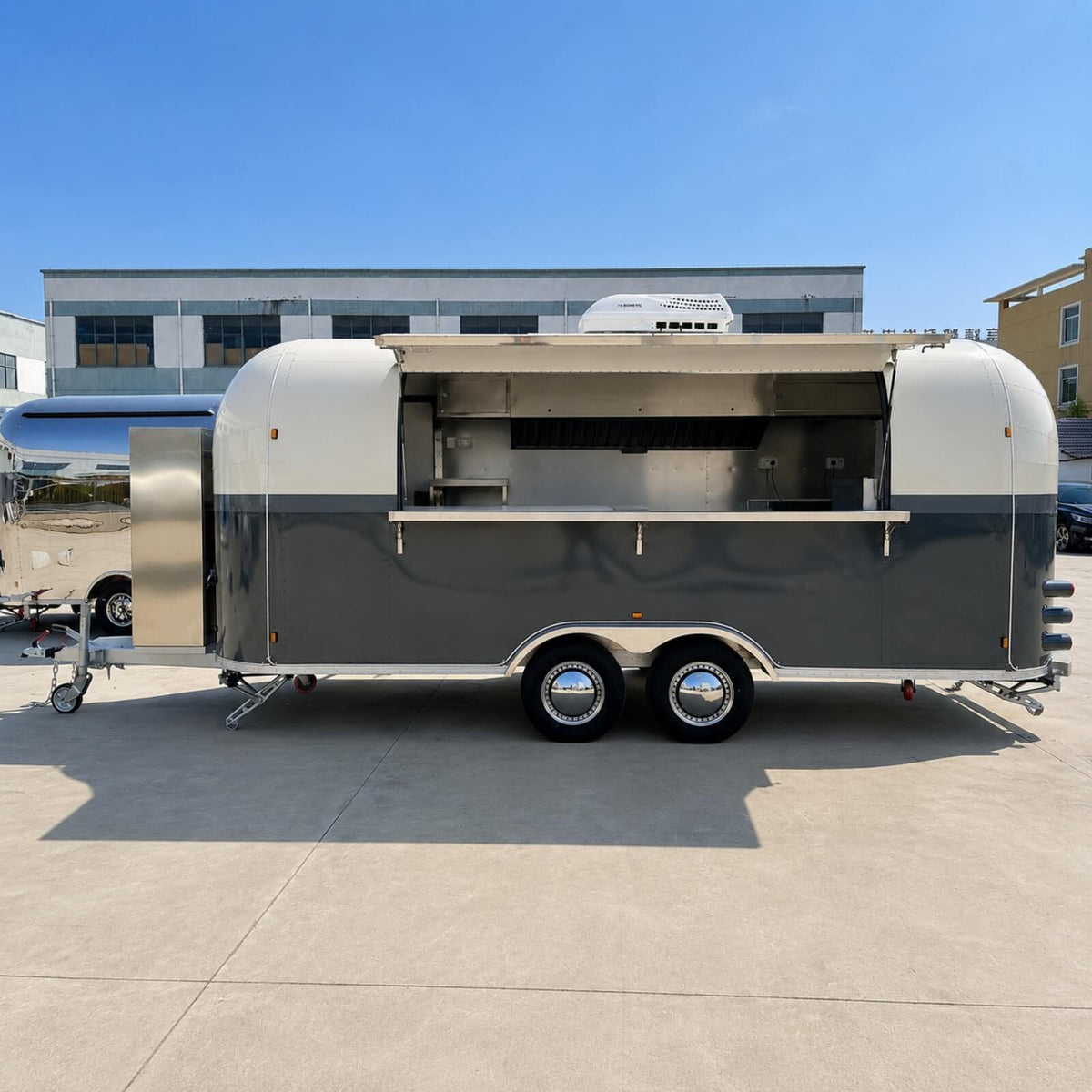Custom Airstream food trailer side view open – full-length service counter dark grey cream finish by Isabella Trailer