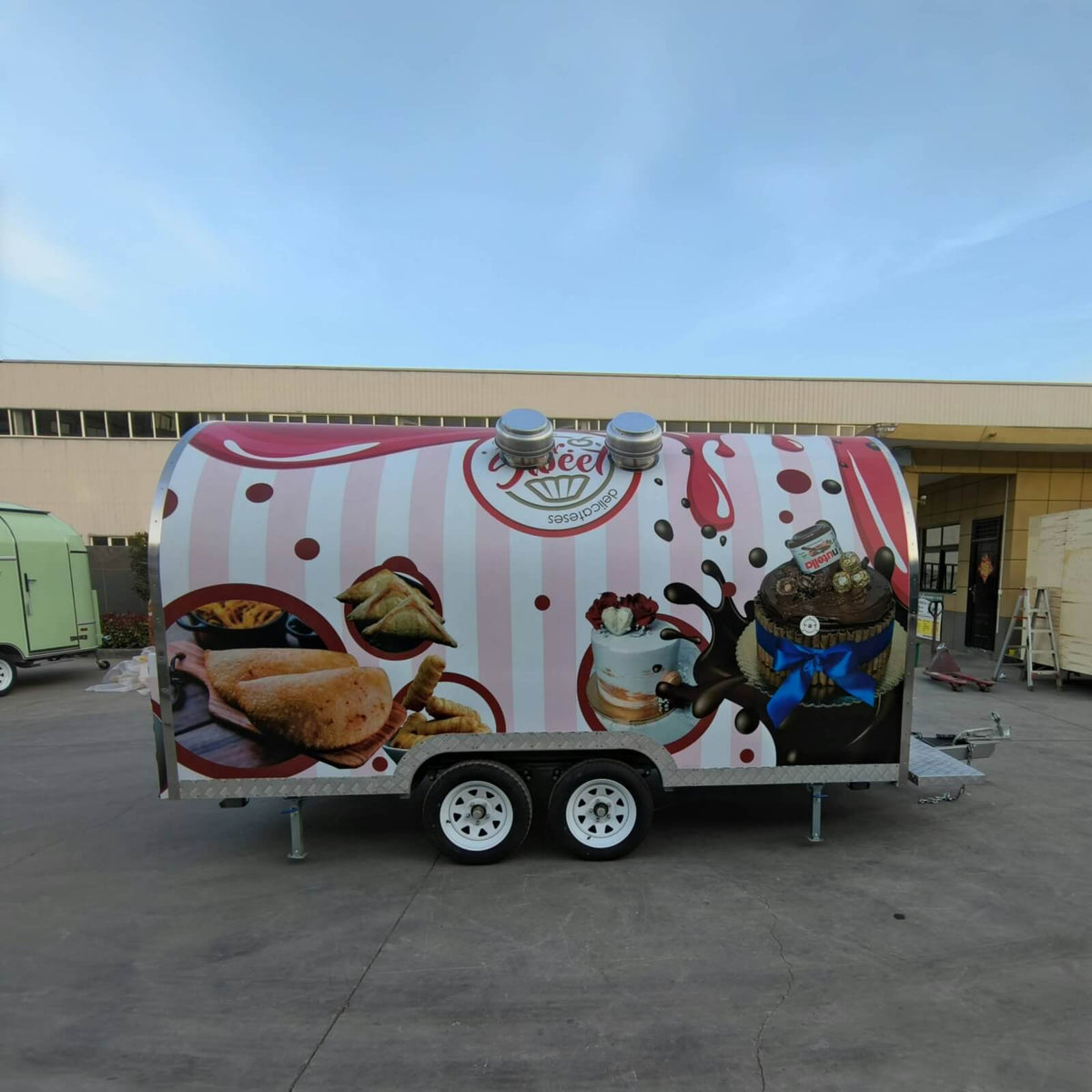 Custom bakery trailer for sale with rounded exterior design and dessert-themed branding