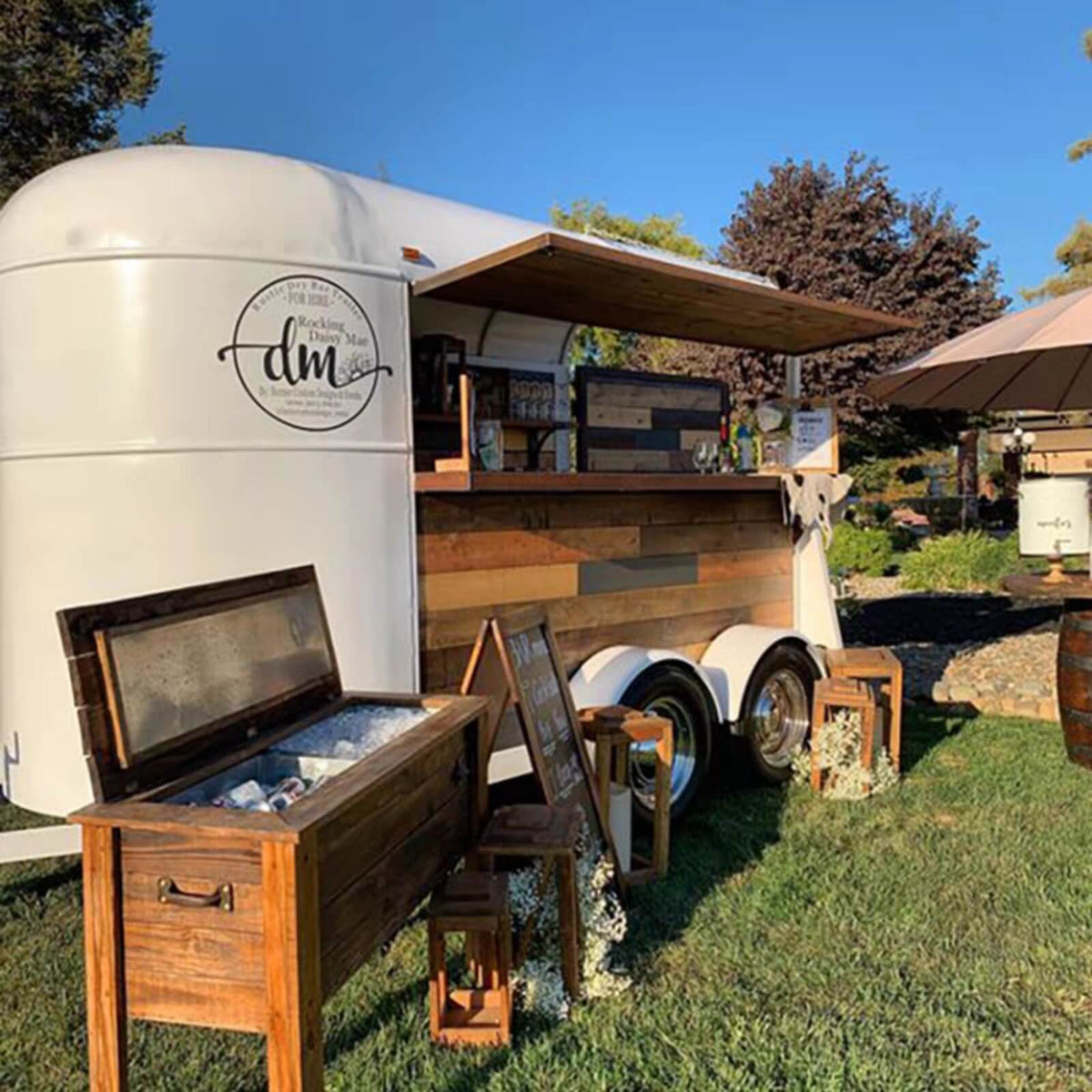 Custom horse trailer bar at vineyard – Rocking Daisy Mae wood panel open canopy by Isabella Trailer