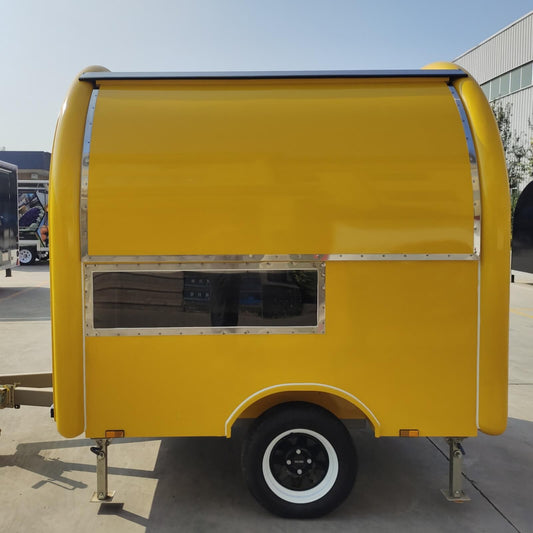 Custom yellow rounded mobile food trailer side view closed – single axle compact design by Isabella Trailer