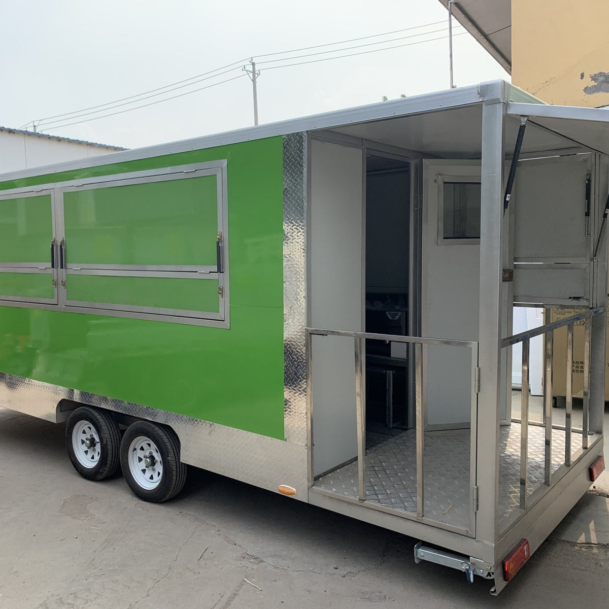 Green food trailer for sale with 3 serving windows and rear entry door – custom concession trailer with stainless steel interior