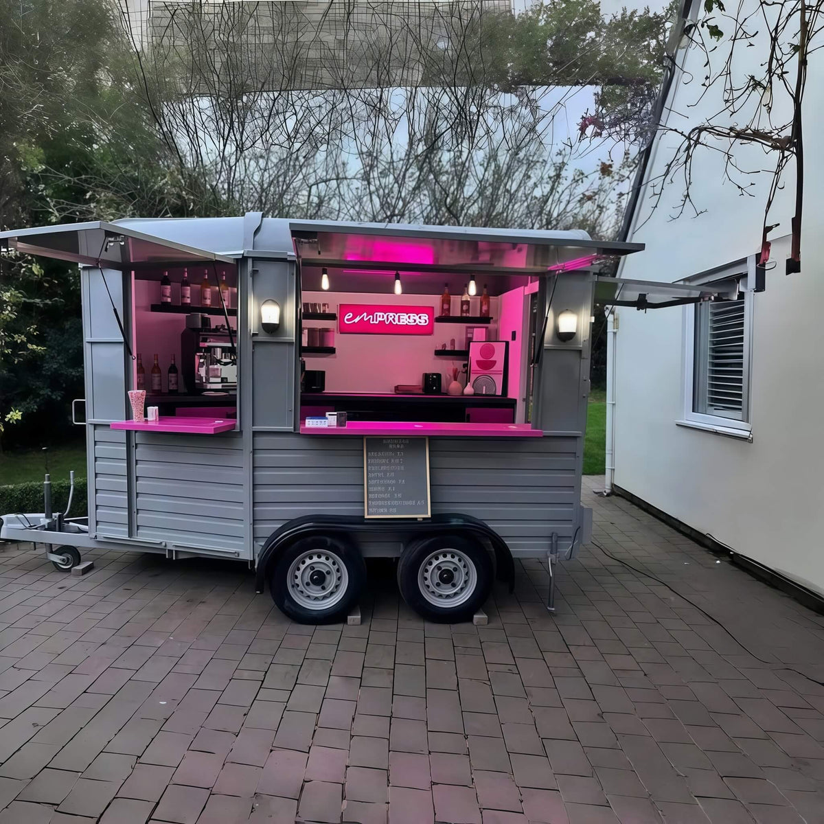 Horse trailer mobile bar at night – pink neon lighting espresso setup Empress branding by Isabella Trailer