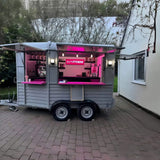 Horse trailer mobile bar at night – pink neon lighting espresso setup Empress branding by Isabella Trailer