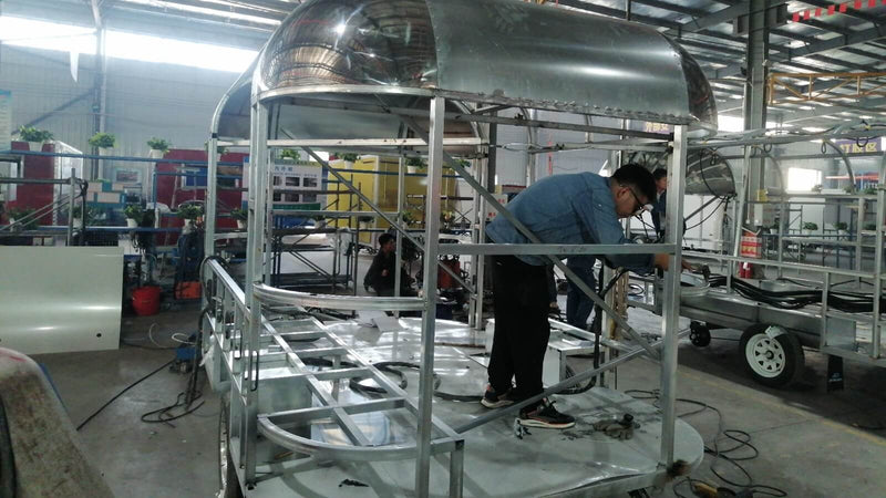Skilled worker assembling airstream food trailer frame – Isabella Trailer factory Zhengzhou