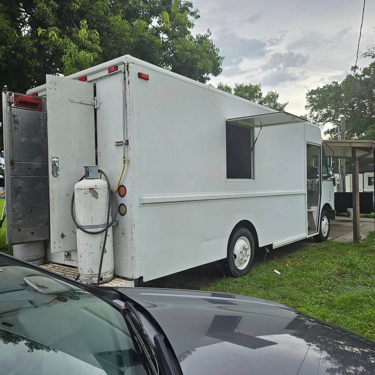 White step van Mexican food truck rear view with LP gas tank and serving window – fully equipped mobile catering truck for sale