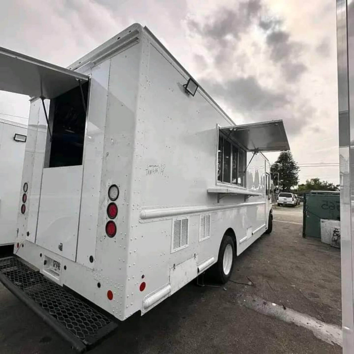 White step van Mexican food truck rear side view with serving window and awning fully open – large mobile catering truck for sale