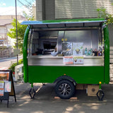 Custom green small food trailer for sale — full-width lift window open for service, street operation | Isabella Trailer