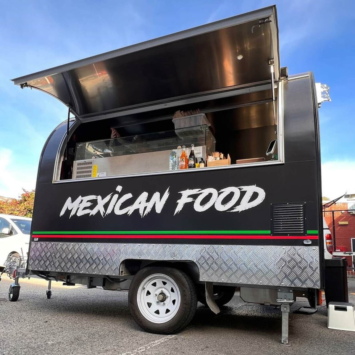 8ft rounded Mexican food trailer with custom Sugar Skull wrap