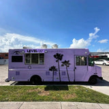 Lavender taco food truck side view with custom palm tree wrap and serving window – mobile street food catering truck for sale