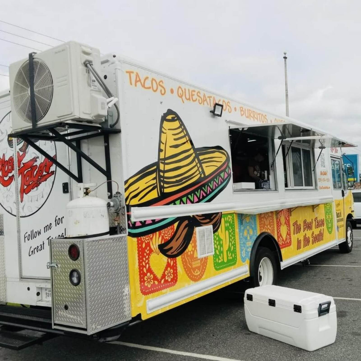Mexican-themed taco food truck with colorful sombrero wrap, open serving window and tacos burritos menu – custom mobile catering truck for sale